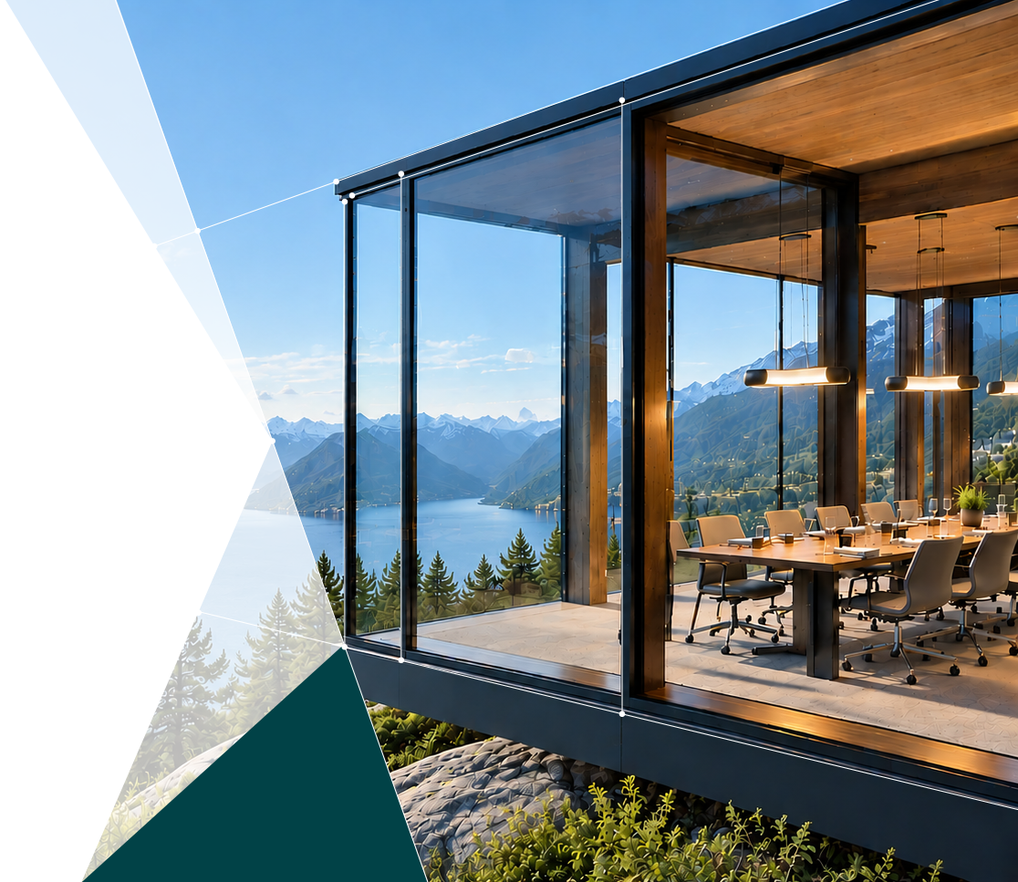 Glass-walled meeting room overlooking a mountain lake in daylight